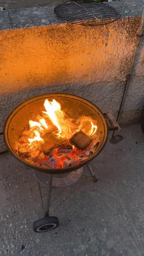 a grill with a fire in it on the street at Baràka - Bungalow sulla spiaggia in Donnalucata