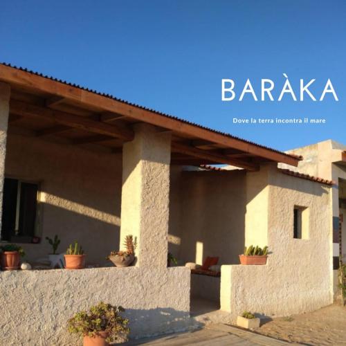 a building with potted plants on the side of it at Baràka - Bungalow sulla spiaggia in Donnalucata