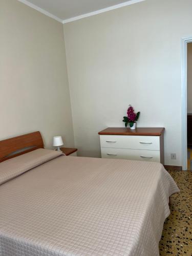 a bedroom with a bed and a table with a plant on it at Palazzina Salodium INCANTO - ARMONIA - ENERGIA in Salò