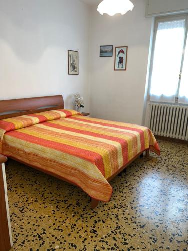 a bedroom with a large bed with a colorful bedspread at Palazzina Salodium INCANTO - ARMONIA - ENERGIA in Salò