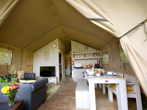 a living room and kitchen of a camper caravan at Riverwood Farm Glamping Safari Tent in Talaton