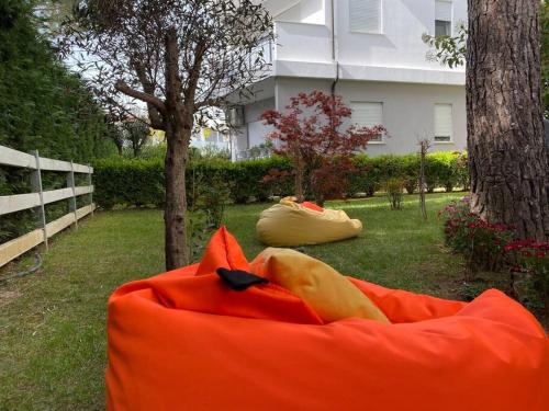 a large orange blob sitting in the grass at Blue Garden Villa, Gjiri i Lalezit in Durrës