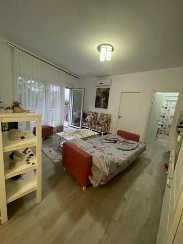 a bedroom with a bed and a table in it at Blue Garden Villa, Gjiri i Lalezit in Durrës