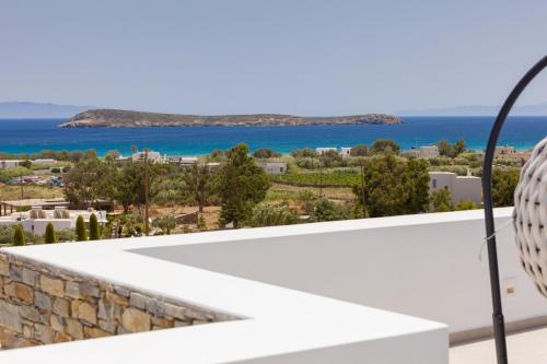 a view of the ocean from the balcony of a house at Golden Bay luxury villas and suites in Chrissi Akti