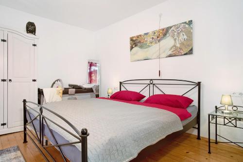 a bedroom with a large bed with red pillows at Haus Rosi in Friedrichshafen