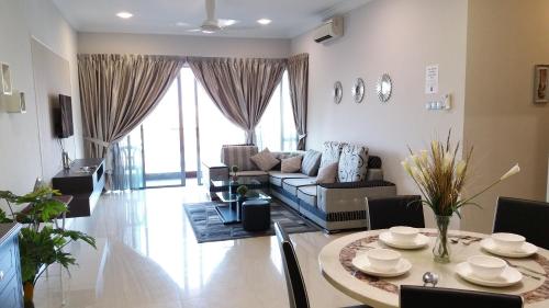 a living room with a table and a couch at AJ Suites @ Loft Imago KK in Kota Kinabalu