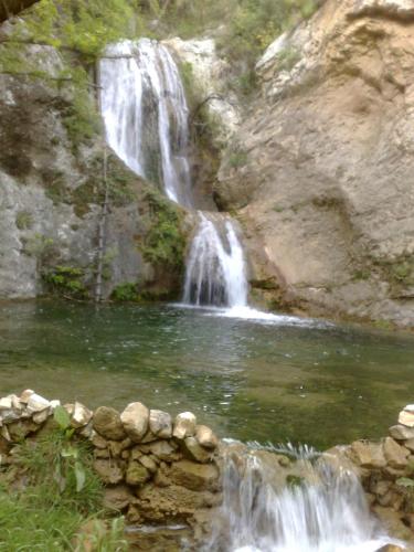 a waterfall in front of a pool of water at Yannis Hotel in Krinídhes