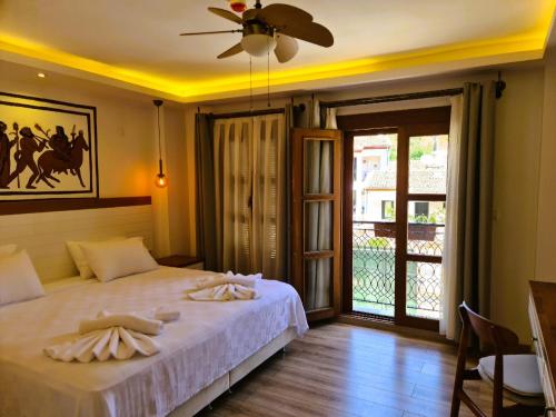 a bedroom with a bed and a ceiling fan at in Ephesus Hotel and Art Galery in Selcuk