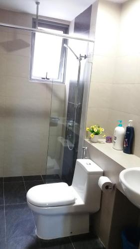 a bathroom with a toilet and a shower and a sink at AJ Suites @ Loft Imago KK in Kota Kinabalu