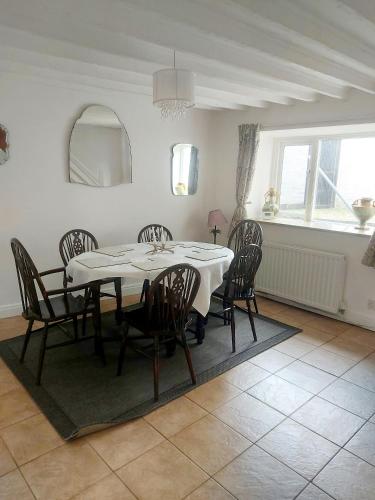 a dining room with a table and chairs at York House in Conwy