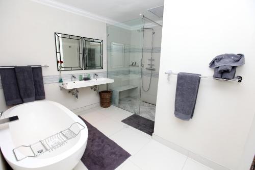 a bathroom with a toilet and a sink and a shower at Indaba Hotel, Spa & Conference Center in Johannesburg