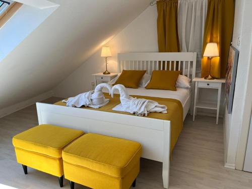 a bedroom with a large bed with a yellow stool at Central apartments Bol in Bol