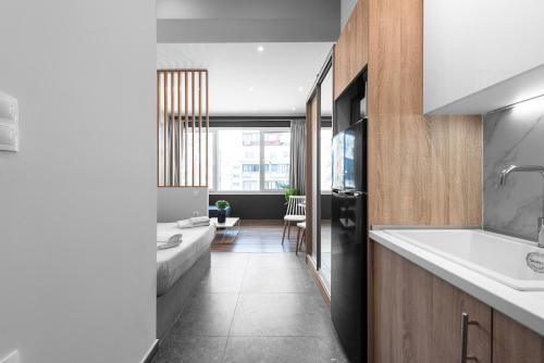 a bathroom with a sink and a tub and a sink at WallStreet, The Luxury Suites in Thessaloniki