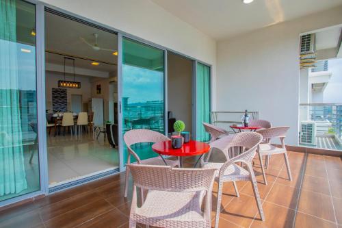 a room with tables and chairs and a balcony at AJ Suites @ Loft Imago KK in Kota Kinabalu
