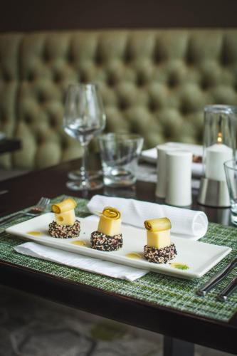 a table with a plate of food on a table at Indaba Hotel, Spa & Conference Center in Johannesburg