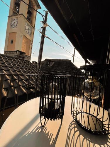 a clock tower and two bird cages on top of a building at Residenza Valentino in Locarno
