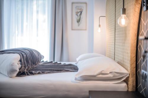 a bedroom with a bed with a pillow and a window at B&B Zur Traube in Vipiteno