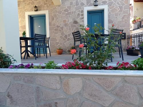 a patio with chairs and flowers in front of a building at Shining Star Petra in Petra