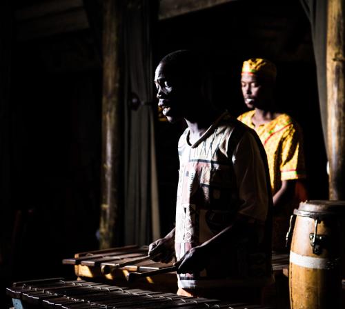 two men standing in a dark room at Indaba Hotel, Spa & Conference Center in Johannesburg