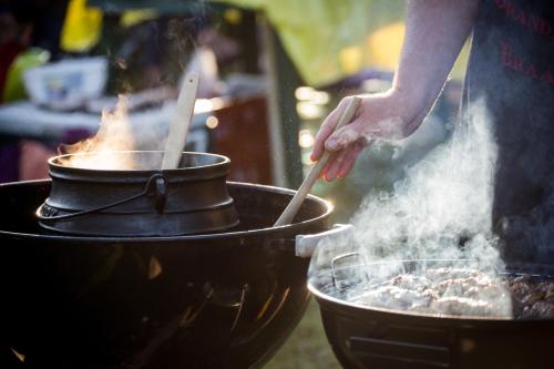 a person is cooking food in a grill at Indaba Hotel, Spa & Conference Center in Johannesburg