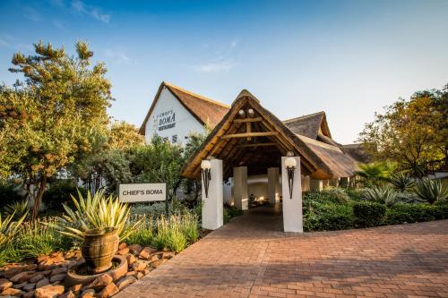 a resort building with a sign that reads sussex at Indaba Hotel, Spa & Conference Center in Johannesburg