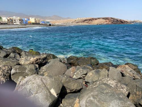 a group of rocks on the ocean near the water at Sarahs Kite Vivienda Vacacional en Playa del Burrero in Playa del Burrero