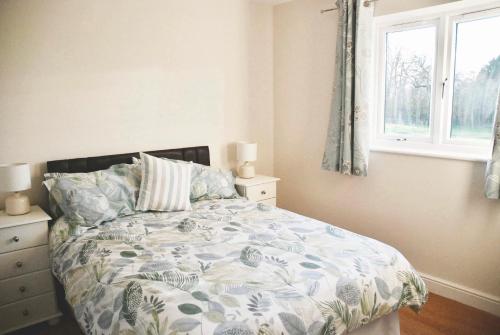 a bedroom with a bed and a window at Lake House Annexe - beautiful countryside retreat in Bristol