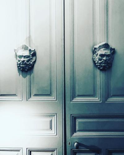 a pair of wooden doors with mirrors on them at La Maison des Roses in Moulins