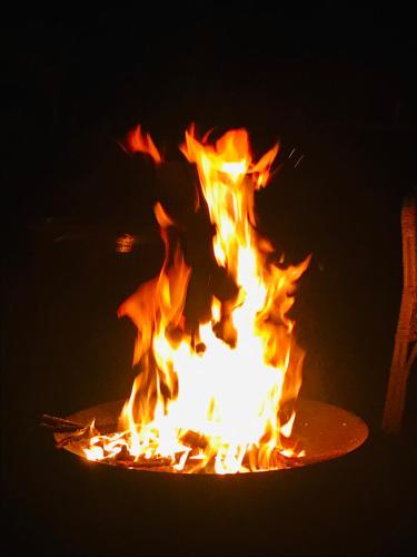 a person is jumping over a camp fire at La Maison des Roses in Moulins