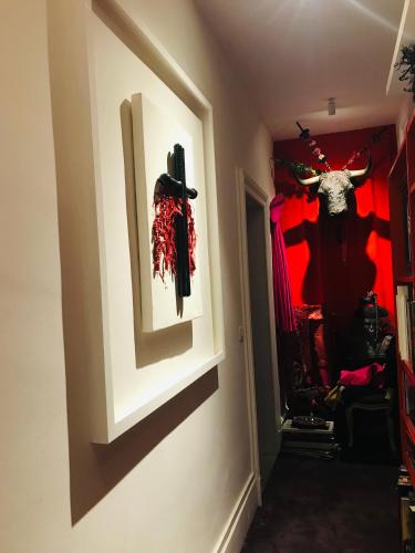 a hallway with a wall with skulls on the wall at La Maison des Roses in Moulins