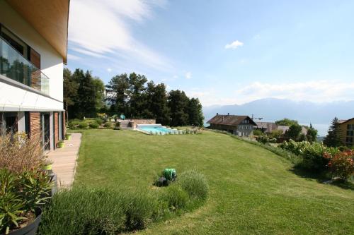 a yard with a swimming pool and a house at Montreux Holiday Home in Montreux