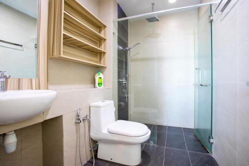 a bathroom with a toilet and a sink and a shower at AJ Suites @ Loft Imago KK in Kota Kinabalu