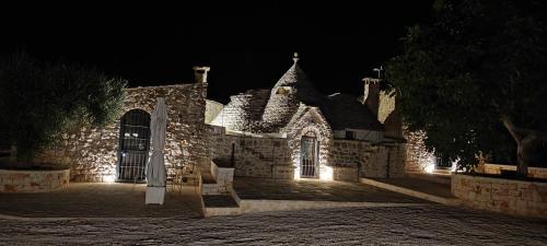 a building at night with lights on it at Villa "Il Trullo di Filomena" in Castellana Grotte