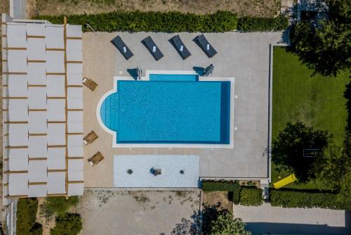 an overhead view of a swimming pool in a yard at Melki for 12 people with private pool in Klis