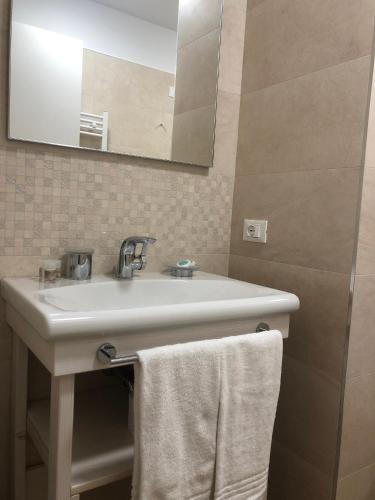 a bathroom with a white sink and a mirror at Hotel Italia in Sacile