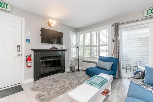 a living room with a blue couch and a fireplace at Blue Heart Mountain Studio Dream Walk to slopes, tennis in Blue Mountains