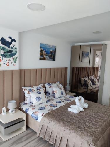 a bedroom with a bed with a stuffed animal on it at Euphoria Olimp in Olimp