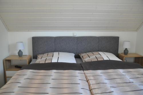 a bedroom with a large bed with two night stands at Vechtestübchen - Nordhorn in Nordhorn