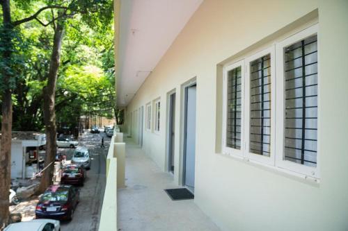 a building with windows and a street with parked cars at Habitat15@airlines in Bengaluru