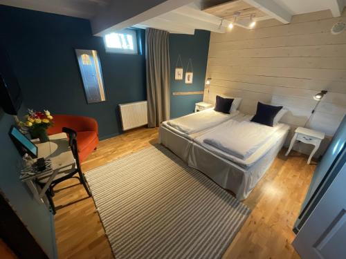 a bedroom with a bed and a table and a couch at Davids Kulle in Ronneby