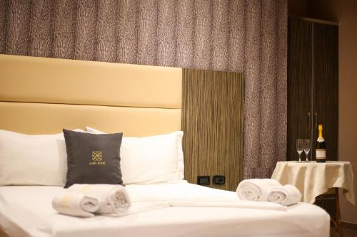 a hotel room with a bed with towels on it at Aliko Hotel in Vlorë