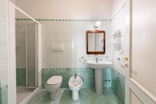 a bathroom with a sink and a toilet and a mirror at Casa Ghibellina by Mmega in Florence