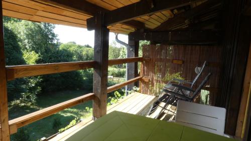 a view from the porch of a cabin with chairs at Chatrou in Châtelraould-Saint-Louvent