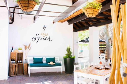 a patio with a blue couch and a table at Indaba Hotel, Spa & Conference Center in Johannesburg
