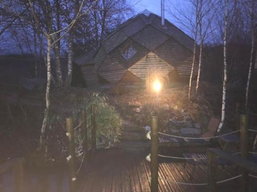 a house with a light in front of it at night at domaine des planesses in Ferdrupt