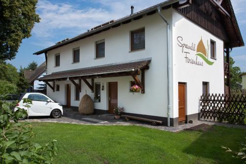 a house with a car parked in front of it at Spreewaldferienwohnungen in Lübben