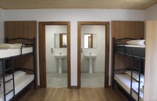 Våningssäng eller våningssängar i ett rum på Albergue Rectoral San Mamede da Pena EXCLUSIVE FOR PILGRIMS