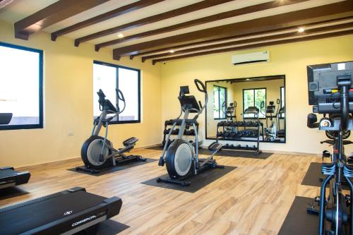 a gym with treadmills and elliptical machines at Aya Sophia Villa Garden Hotel in Dar es Salaam