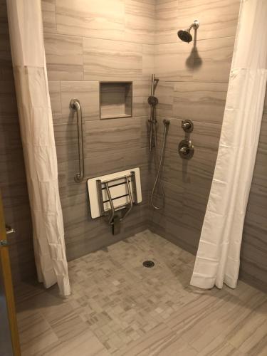 a shower stall in a bathroom with a shower curtain at Parkway Motel in Neenah