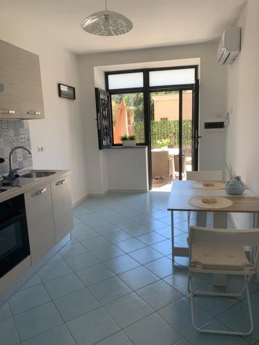 a kitchen with a table and a dining room at ACQUAMARINA APPARTAMENT in Procida